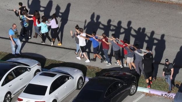 Video footage from the scene showed students being evacuated in small groups Video footage from the scene showed students being evacuated in small groups
