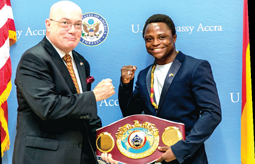 Isaac Dogboe (left) presents his belt to Ambassador Robert Jackson during the visit to the US Enbassy Isaac Dogboe (left) presents his belt to Ambassador Robert Jackson during the visit to the US Enbassy