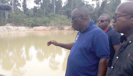 Mr Kwadwo Owusu Afriyie, Chief Executive Officer of the Forestry Commission explaining a point to the media while standing beside one of the trenches. With him is the District Chief Executive of Amansie Central, Mr Asamoah Boateng Mr Kwadwo Owusu Afriyie, Chief Executive Officer of the Forestry Commission explaining a point to the media while standing beside one of the trenches. With him is the District Chief Executive of Amansie Central, Mr Asamoah Boateng