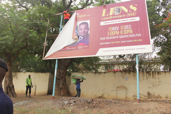 A billboard being pulled down by some officials of the AMA during the exercise.