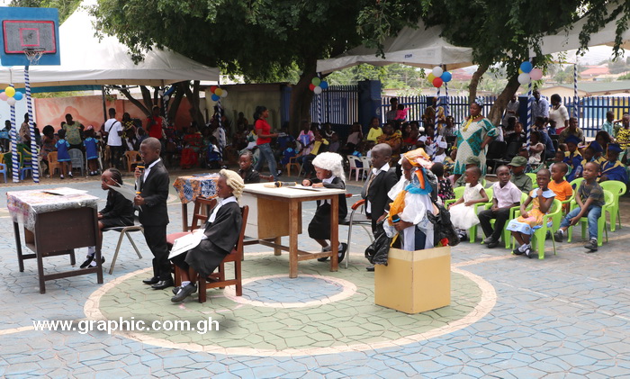 The graduands enacting a court scene