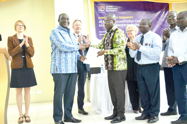 Mr Alan Kyerematen, the Minister of Trade and Industry (left), handing over the certificate to Prof. Alex Dodoo, GSA Director General. Looking on are the German ambassador and other dignitaries
