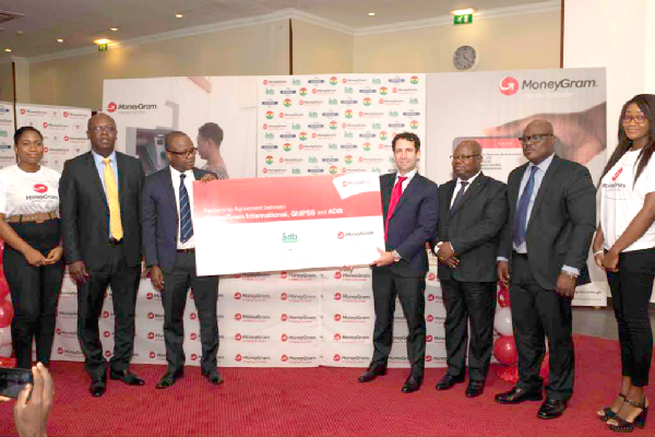 Dr Maxwell Opoku Afari (3rd left) and Mr John Gely displaying a dummy of the agreement