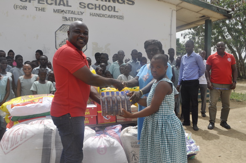 Jerry Sam, Director of Programmes at Penplusbytes in a symbolic gesture with an inmate and Headmistress, Madam Ophelia Kushigbor