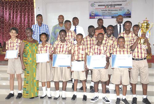 Pupils of Dayspring Montessori Int. School  displaying their certificates and the trophy.