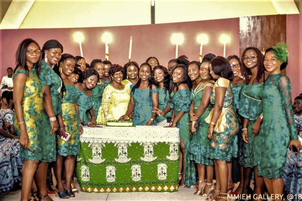 • Ms Lilly Djima (arrowed) helping the old students to cut the anniversary cake