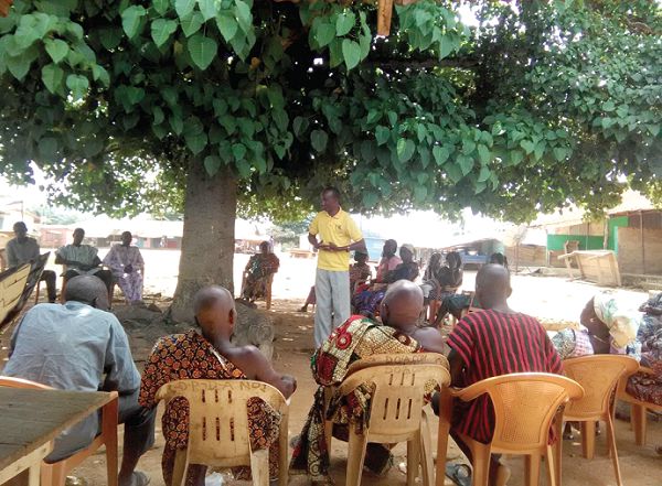 Mr Daniel Agbesi Latsu, NCCE District Director (standing) addressing participants Mr Daniel Agbesi Latsu, NCCE District Director (standing) addressing participants