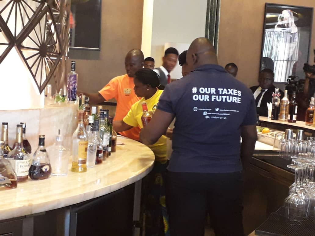 GRA officials inspecting bottles at the bar of Kempinski Gold Coast GRA officials inspecting bottles at the bar of Kempinski Gold Coast