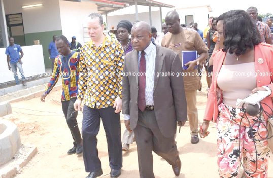 Mr Kwaku Agyemang-Manu (2nd left) and Mr Albert Tackie (left) touring the Sege Polyclinic project. INSET: A view of the Sege Municipal Polyclinic Mr Kwaku Agyemang-Manu (2nd left) and Mr Albert Tackie (left) touring the Sege Polyclinic project. INSET: A view of the Sege Municipal Polyclinic