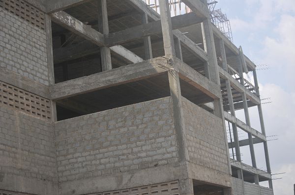 The uncompleted storey building from which the victims jumped. INSET: One of the victims on admission at the Legon Hospital Pictures: EBOW HANSON The uncompleted storey building from which the victims jumped. INSET: One of the victims on admission at the Legon Hospital Pictures: EBOW HANSON