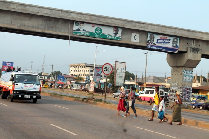 Library photo: Some pedestrians trying to cross the highway