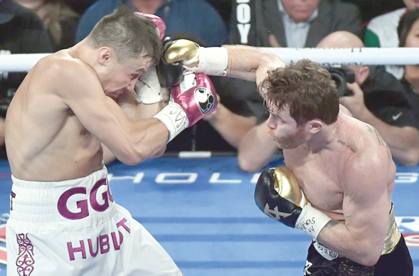 Camelo Alvarez(right) launches an attack against Gennady Golovkin Camelo Alvarez(right) launches an attack against Gennady Golovkin