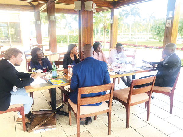 Dr Robert Bright Mawuko Sogbadji (right) interacting with members of the media including Mr Ryan Collyer (left). 