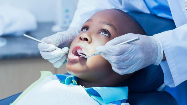 Dr Filson attending to a child. Dr Filson attending to a child.