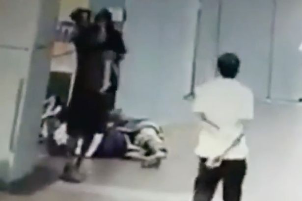 A man can be seen picking the little girl up and carrying her away from her sleeping mum A man can be seen picking the little girl up and carrying her away from her sleeping mum