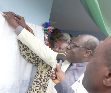 Rt Rev. Prof. J.O.Y. Mante, the Moderator of the PCG, unveiling the plaque after the dedication of the centre Rt Rev. Prof. J.O.Y. Mante, the Moderator of the PCG, unveiling the plaque after the dedication of the centre