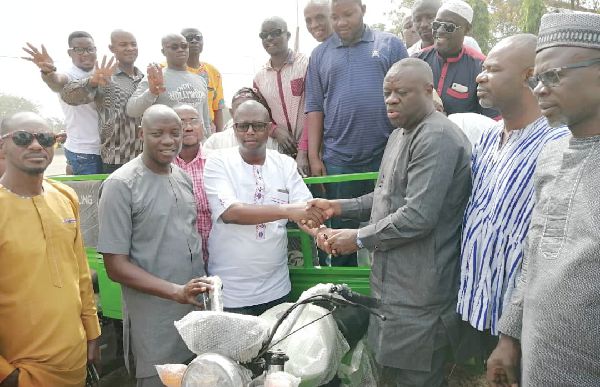 Dr Ibrahim Mohammed Awal (3rd right) handing over the keys to one of the tricycles to Mr Sule Salifu Dr Ibrahim Mohammed Awal (3rd right) handing over the keys to one of the tricycles to Mr Sule Salifu