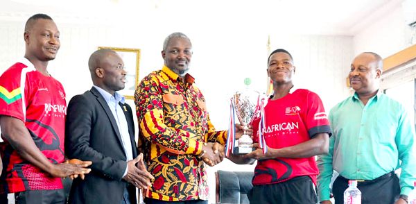 A member of the rugby team presenting the trophy to the Deputy minister of Youth and Sports, Mr Perry Okudzeto, as Prof. Peter Twumasi (2nd left), NSA director General, looks on A member of the rugby team presenting the trophy to the Deputy minister of Youth and Sports, Mr Perry Okudzeto, as Prof. Peter Twumasi (2nd left), NSA director General, looks on
