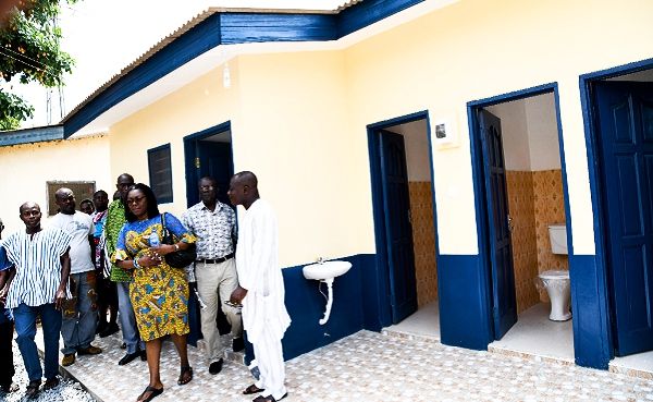Mrs Ursula Owusu-Ekuful being conducted round the 16-seater toilet facility by some police personnel at the Dansoman Police Station. Picture: EBOW HANSON Mrs Ursula Owusu-Ekuful being conducted round the 16-seater toilet facility by some police personnel at the Dansoman Police Station. Picture: EBOW HANSON