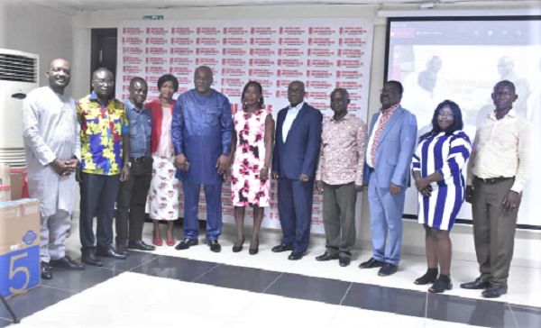 Mr Carlos Kingsley Ahenkorah(5th left) with the award winners. With them is Mr Tony Oteng-Gyasi (5th right) MD of TCCL