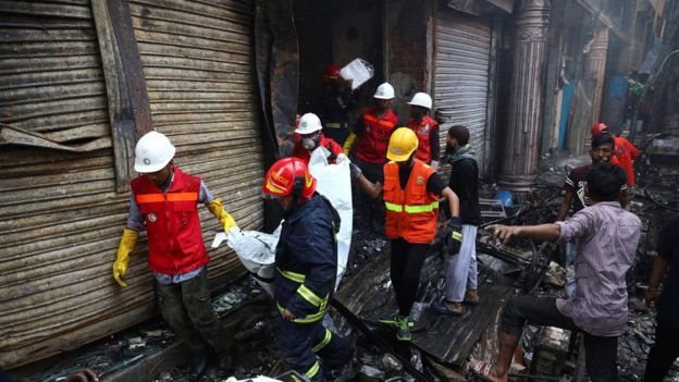 Volunteers recovering a body from a burnt warehouse Volunteers recovering a body from a burnt warehouse