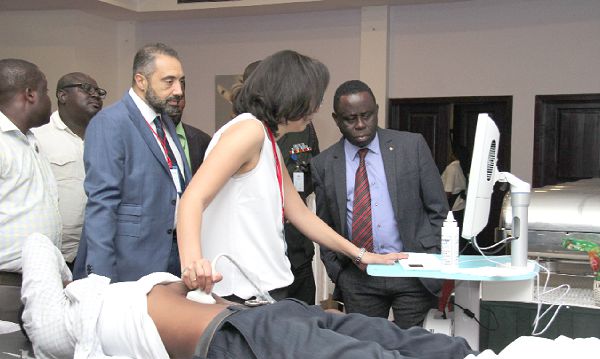 Madam Jacklin George, an Application specialist, demonstrating to Mr Mohammed Elkaliouby (behind madam Gorge), a Managing Partner, Africano Healthcare, and Dr Daniel Asare (right), CEO, Korle Bu Teaching Hospital, how the Eco Station Machine, used for measuring bone density, works. Picture: BENEDICT OBUOBI Madam Jacklin George, an Application specialist, demonstrating to Mr Mohammed Elkaliouby (behind madam Gorge), a Managing Partner, Africano Healthcare, and Dr Daniel Asare (right), CEO, Korle Bu Teaching Hospital, how the Eco Station Machine, used for measuring bone density, works. Picture: BENEDICT OBUOBI