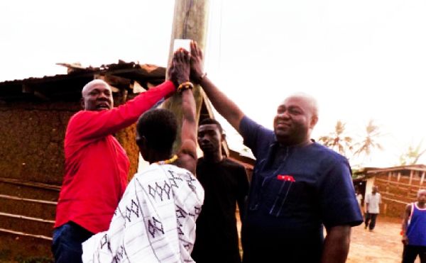 Mr George Aboagye (left), the MP, and Mr Alex Inkoom (right), the DCE, being assisted to inaugurate power supply in one of the communities Mr George Aboagye (left), the MP, and Mr Alex Inkoom (right), the DCE, being assisted to inaugurate power supply in one of the communities