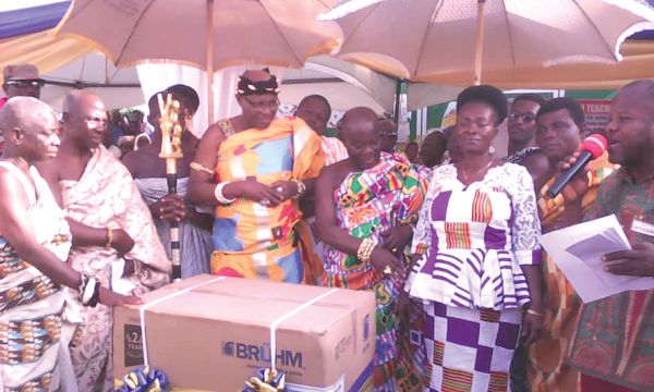  Nana Effah Opinamang III, the Chief of Kwahu Obomeng (left) and Nana Kwasi Abankwah about to hand over the Best Teacher award to Madam Regina Serwah (right)