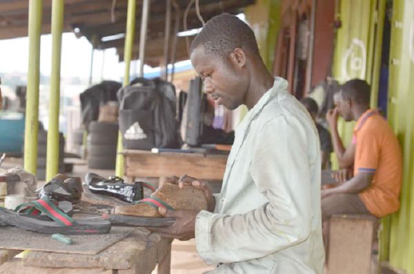 A ‘shoe maker’ at work at the Asafo shoe-making hub A ‘shoe maker’ at work at the Asafo shoe-making hub
