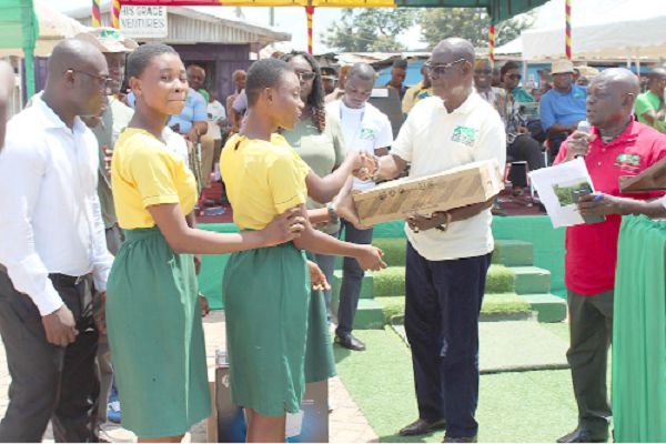 Participants in the debate from the Twene Amanfo Senior High/Technical School, Sunyani, receiving a desktop computer from Nana Owusu Nsiah, Member of the Council of State as their prize for emerging as winners in one of the debates 