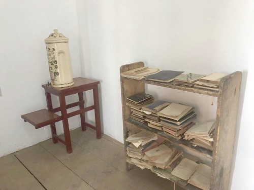 The shelf that held his books and his water cooler