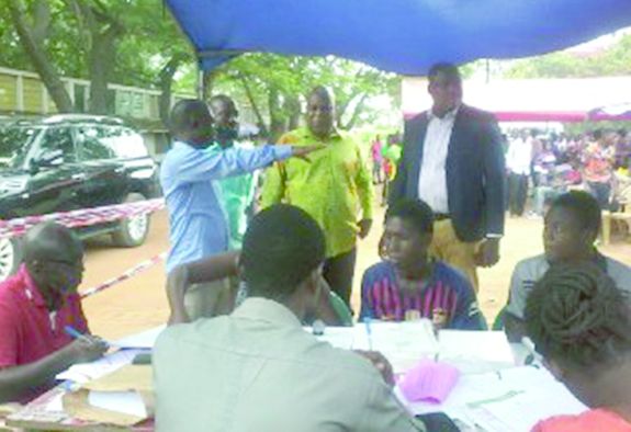   Nana Oduro Numapau (hand stretched), Tema Metropolitan Electoral Officer, explaining the process to the Greater Accra Regional Minister, Mr Ishmael Ashitey (middle). With them is the MCE for Tema, Mr Felix Anang-La (right)