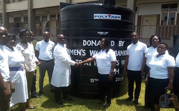 The CEO (right) presenting the tank to Dr Asubonteng. Looking on are officials of the bank and the hospital The CEO (right) presenting the tank to Dr Asubonteng. Looking on are officials of the bank and the hospital