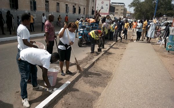 Mr Abraham Jawol (3rd left), MD of Ghana Supply Company Ltd, with some staff members during the clean up exercise