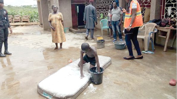 A resident cleaning his mattress