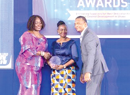  Ms Cynthia Lumor (left) Director of External Affairs, Social Performance and Local Content, presenting an award to Conship one of the company’s suppliers receiving on behalf of the company are Mr and Mrs Macdonald Vasnani