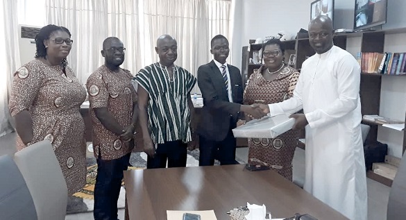 Mr Adam (right) presenting the prize to Evans Tettey Odjer, while Mr Addo and other members of ICAG look on Mr Adam (right) presenting the prize to Evans Tettey Odjer, while Mr Addo and other members of ICAG look on