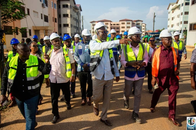 Mr Courage Nunekpeku ( with hand stretch) Managing Director of TDC Ghana Ltd conducting Mr Kenneth Gilbert Adjei, (2nd left) Minister of Works Housing and Water Resources round the buildings at the Kpone Affordable Housing Project site.