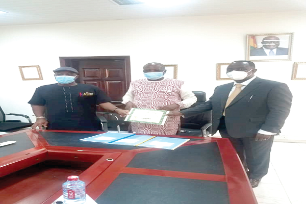 Mr Francis Nyonyo (middle), Board Chairman, NLA, presenting the licence to Mr Alex Dadey (right), Executive Chairman, KGL Technology Ltd, with the support of Mr Kofi Osei-Ameyaw, Director-General, NLA Mr Francis Nyonyo (middle), Board Chairman, NLA, presenting the licence to Mr Alex Dadey (right), Executive Chairman, KGL Technology Ltd, with the support of Mr Kofi Osei-Ameyaw, Director-General, NLA