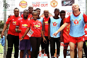 Anim Addo sandwiched by some of the foundation members Manchester United support Nectar Foundation