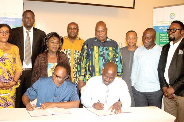 Mr Nii-Noi Adumuah (left), and Mr Noah Tumfo (right), signing the agreement in Accra. Those with them include Ms Cecilia Dapaah (3rd left), Mr Ismael Ashietey (4th right) and other officials. Picture: GABRIEL AHIABOR Mr Nii-Noi Adumuah (left), and Mr Noah Tumfo (right), signing the agreement in Accra. Those with them include Ms Cecilia Dapaah (3rd left), Mr Ismael Ashietey (4th right) and other officials. Picture: GABRIEL AHIABOR