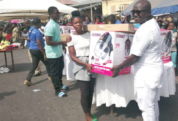 Mr Bannerman (right) presenting a hairdryer to one of the beneficiaries