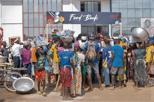 People queueing to receive their foods packs People queueing to receive their foods packs
