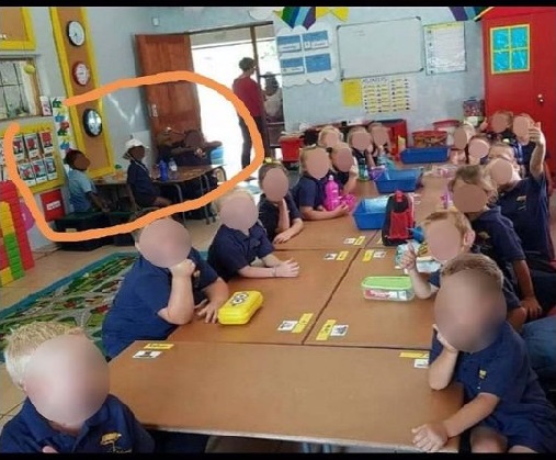 An image of a classroom with black and white children separated sparks controversy in post-apartheid South Africa.