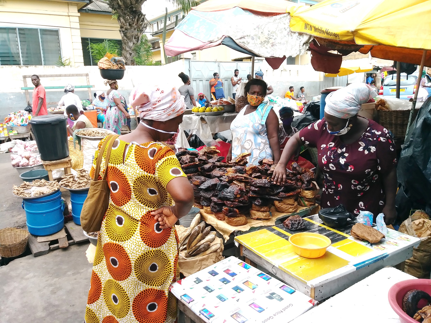 A woman buying some smoked fishes. Adabraka Market; the processed fish centre