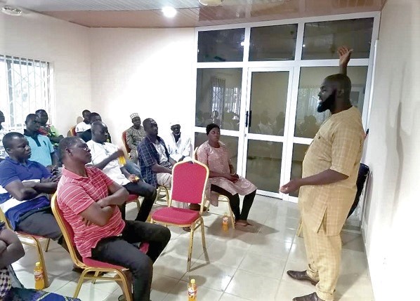 Mr Nurudeen (right) addressing some of the youth Mr Nurudeen (right) addressing some of the youth