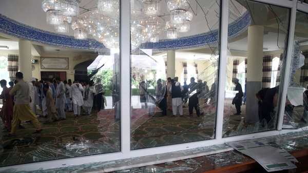People inspect the interior of the Kabul mosque following the blast [Rahmat Gul/AP Photo]