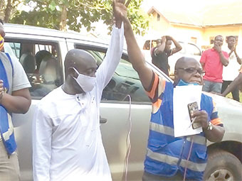 Mr Seth Kofi Darko (right), an officer of the Electoral Commission, holding up Mr Wiredu’s hand to declare him the winner Mr Seth Kofi Darko (right), an officer of the Electoral Commission, holding up Mr Wiredu’s hand to declare him the winner