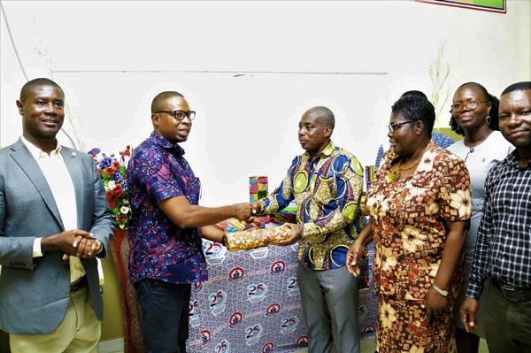 Mr Kwasi Baiden (second left) presenting the items to Prof. Frederick Kwaku Sarfo, Principal of the COLTEK Mr Kwasi Baiden (second left) presenting the items to Prof. Frederick Kwaku Sarfo, Principal of the COLTEK