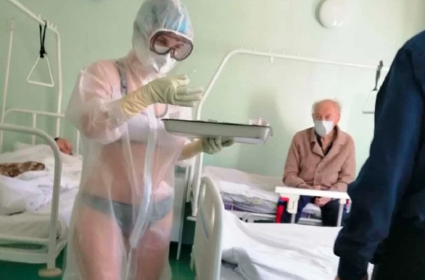 A nurse at a hospital in Tula, Russia, wore nothing but underwear beneath a see-through protective suit, gloves and goggles while working in a COVID-19 ward. A nurse at a hospital in Tula, Russia, wore nothing but underwear beneath a see-through protective suit, gloves and goggles while working in a COVID-19 ward.